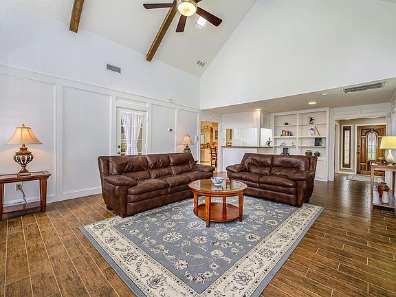 This view of the spacious living room looking towards the entrance foyer and wet bar. Kitchen to the left.