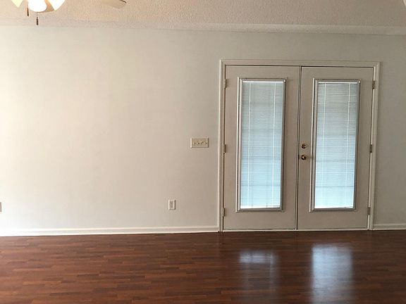 Living room with french doors going out to screened in porch