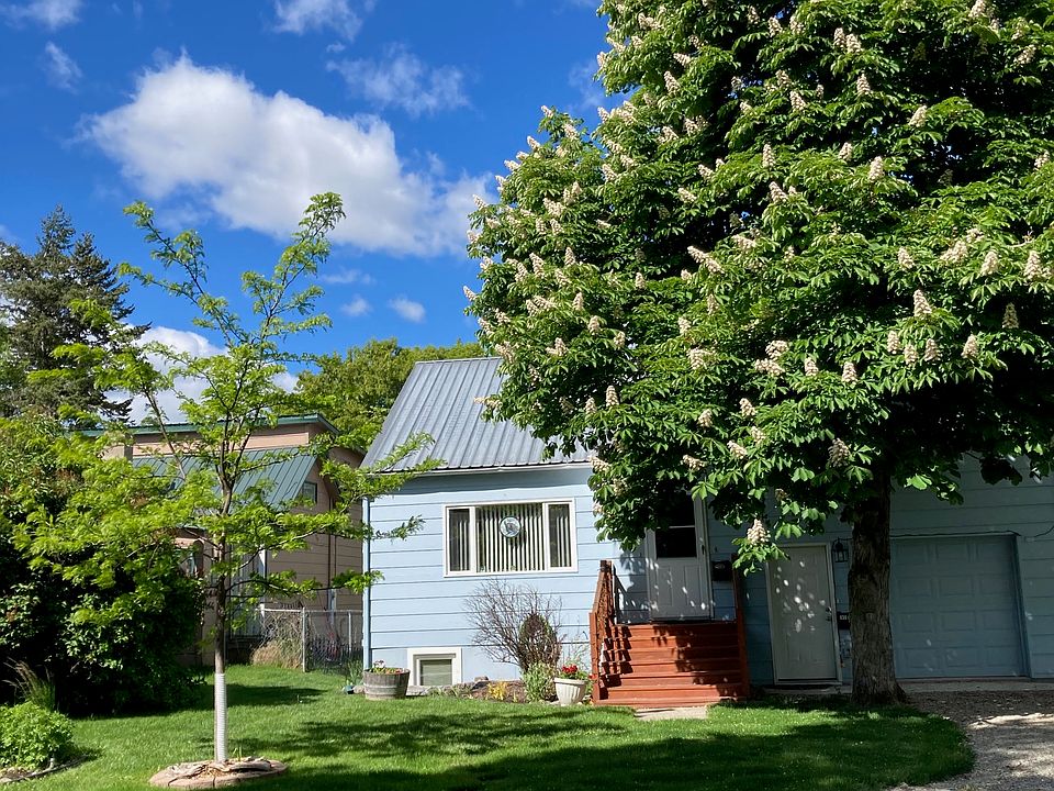 The apartment is behind the tree. Door to the apartment is separate entrance beside the steps. Tree keeps the large bedroom windows shaded in summer.
