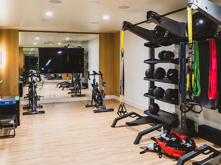 Fitness studio includes a space for yoga, barre, spinning, and TRX workouts