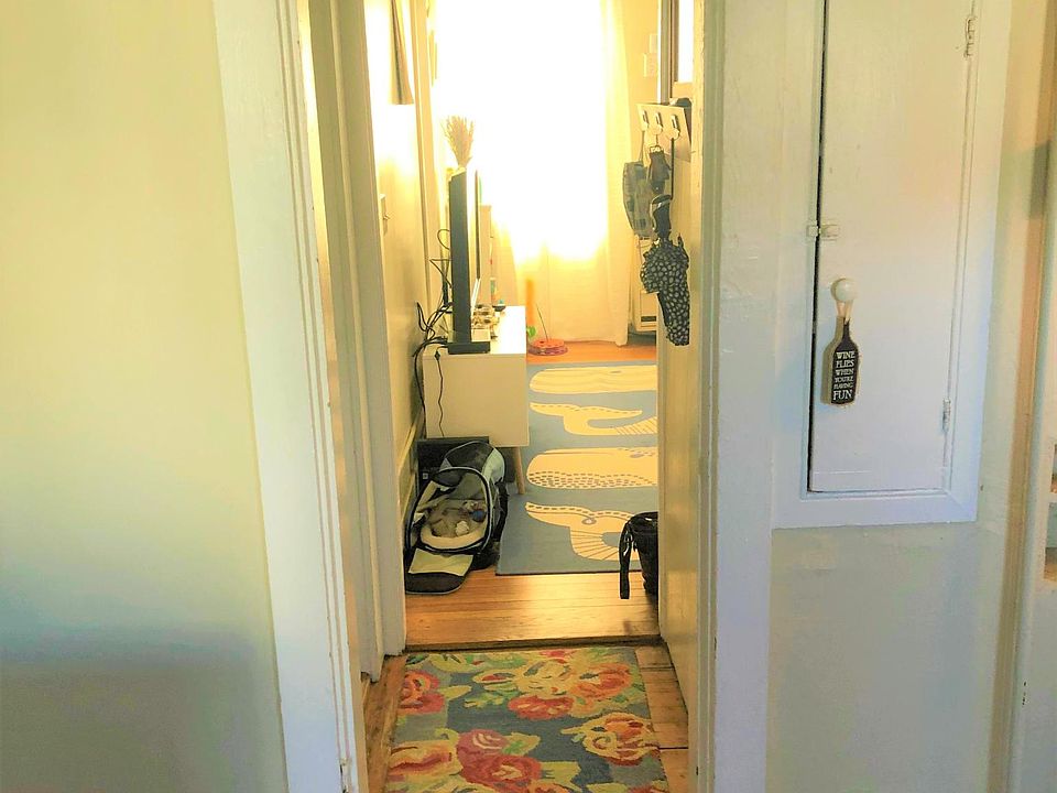 Standing in the kitchen, looking through the entry way to the living room.