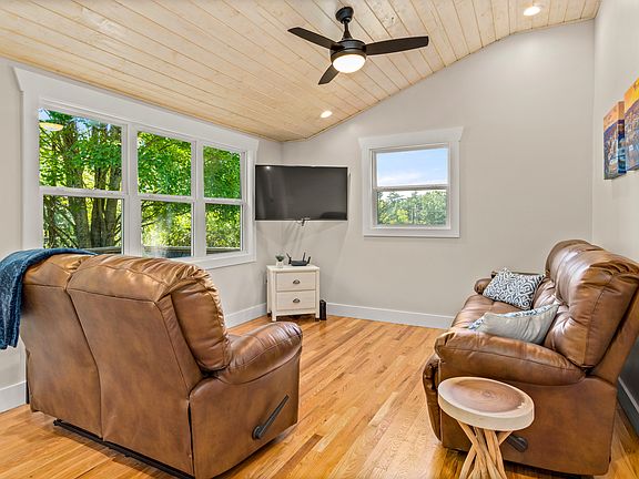 Leather reclining sofas and loads of natural light create an inviting space for relaxing or entertaining.