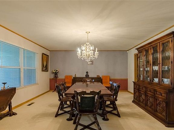 Front living/dining room with large chandelier and big nice windows.  Don't need a dining table? Could be second living and/or game room.