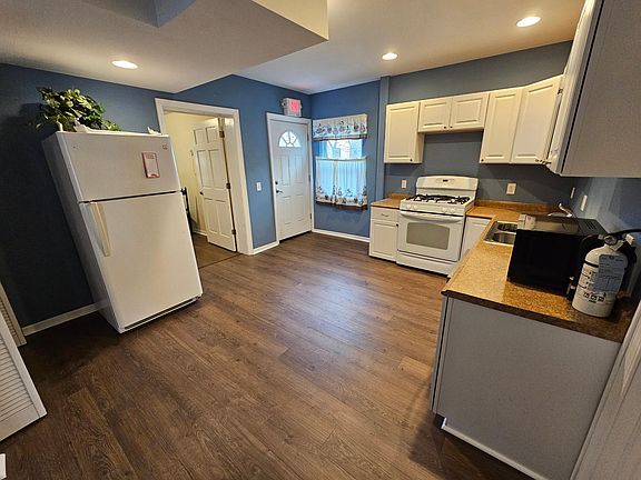 The room next to the fridge is the extra office space. It could be used as an office, a small bedroom or as storage. It has a window that looks to the rear of the building where the alley and parking is located.