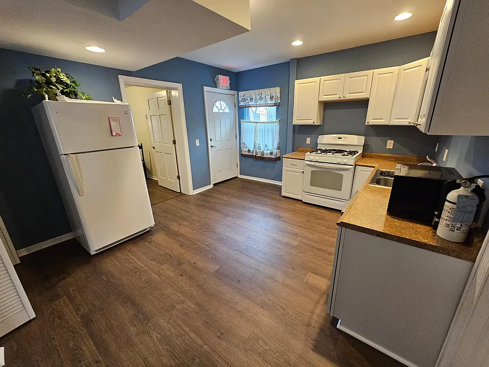 The room next to the fridge is the extra office space. It could be used as an office, a small bedroom or as storage. It has a window that looks to the rear of the building where the alley and parking is located.