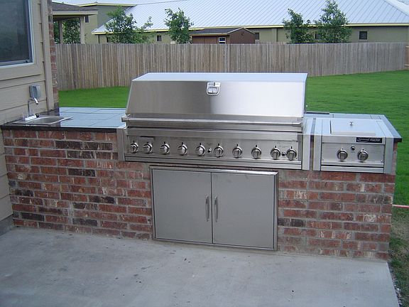 10' brick BBQ, 52" NG gas grill and side burner,  granite counter top, sink