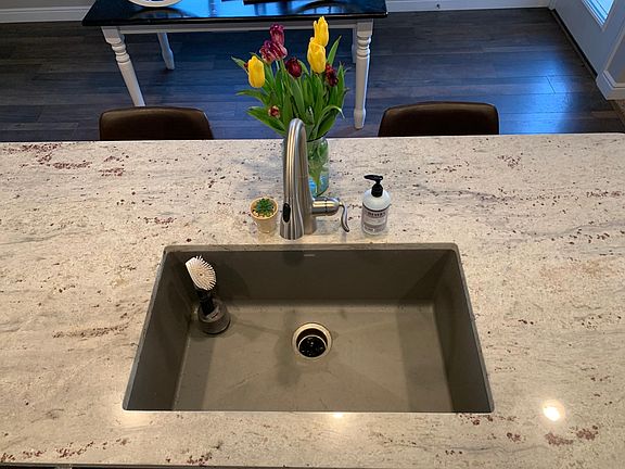 Large island with Blanco composite single bowl sink with garbage disposal.