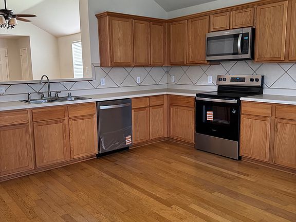 New appliances (electric range, over the range microwave and dishwasher), new kitchen sink faucet, and wood floors in the kitchen.