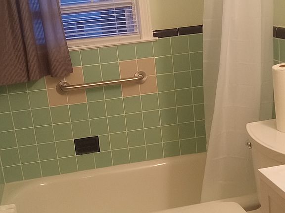 Full bathroom that was re-grouted, new floor installed, walls, ceiling and radiator painted, resurfaced tub.