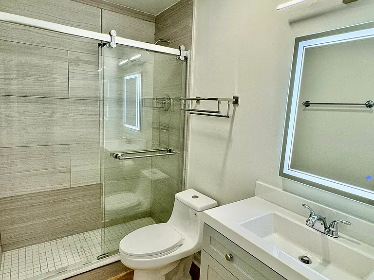 Brand new hallway shower with new toilet, LED mirror and flooring
