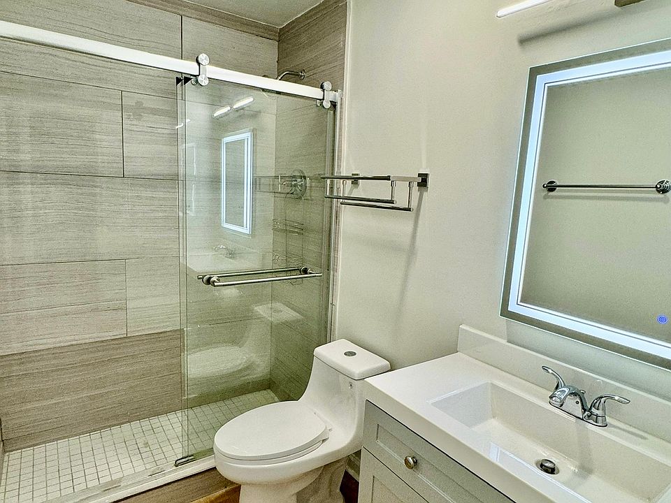 Brand new hallway shower with new toilet, LED mirror and flooring
