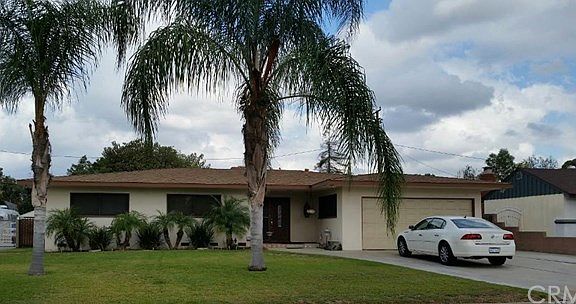 Beautiful West Covina home with mature landscaping and large concrete parking area
