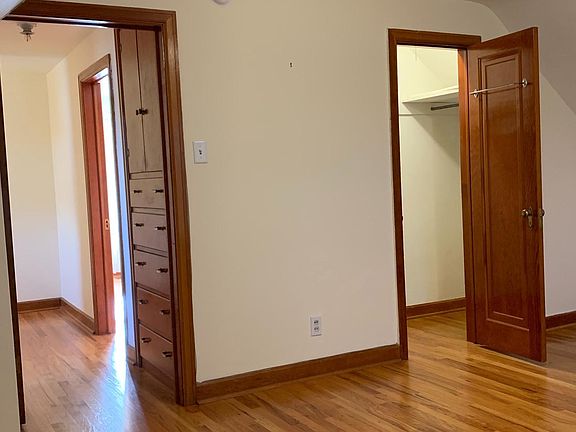 View from western bedroom looking into the hallway build-in and bedroom closet.