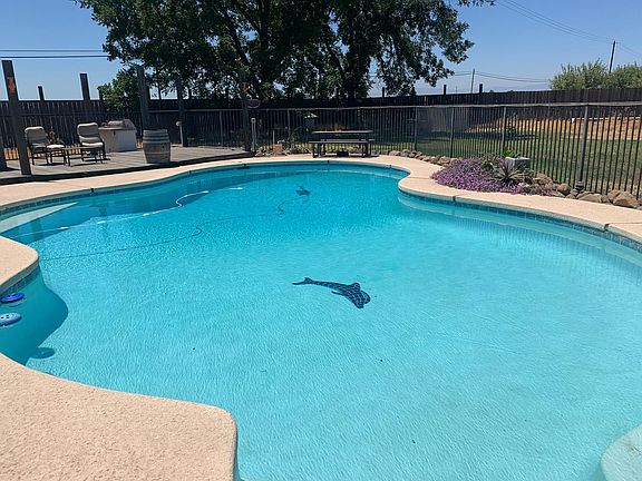 Beautiful pool area with BBQ fenced separate from back yard area