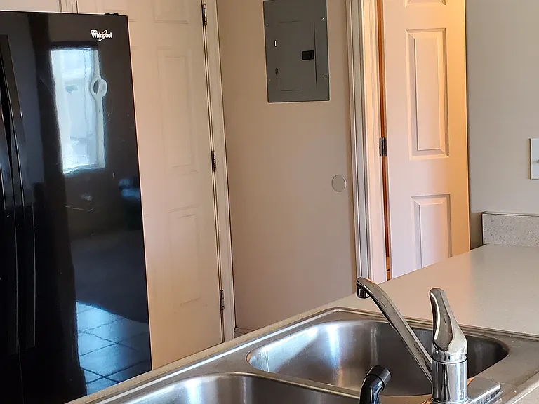 kitchen counter and sink, 1/2 bathroom near garage.