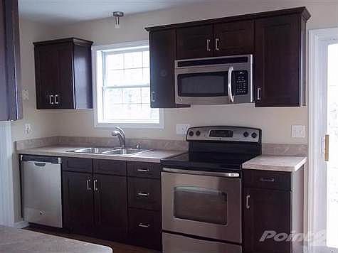 This kitchen is gorgeous! Brand New Custom Dark Espresso Maple Cabinets with Crown molding. These are also brand new Stainless GE appliances with warranties.  The hardwoods have been refinished in contemporary darker tones to compliment the cabinets.