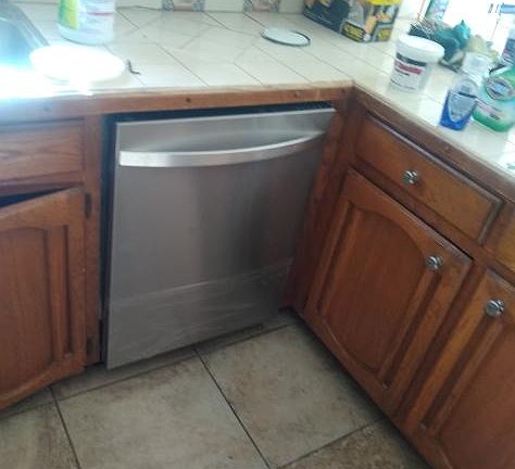 in Kitchen: Tile countertop, oak wood cabinetry, new dishwasher