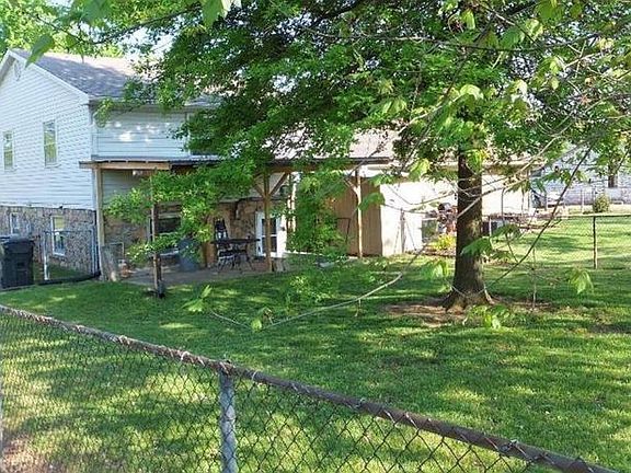 Covered patio with fenced backyard.