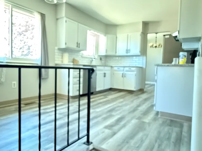 Updated granite kitchen counter tops and newly painted cabinets. New kitchen sink as well
