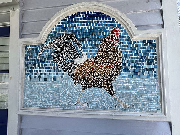 Key West Rooster tile creation meets your entry into this upgraded home.