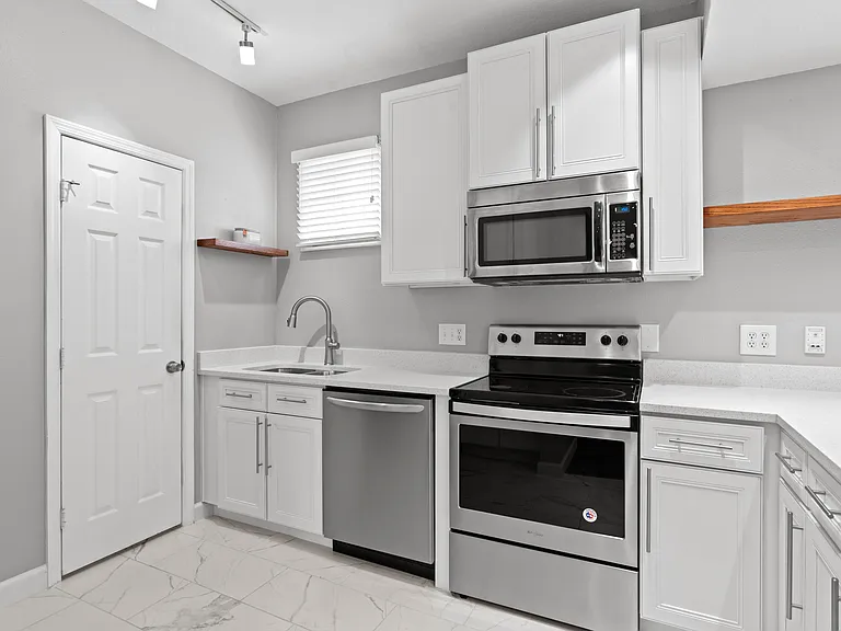 Open Kitchen with stainless steel appliances, walk-in pantry