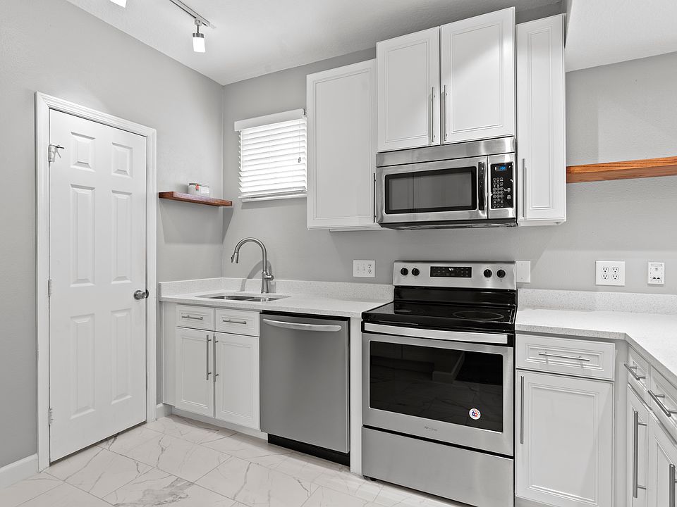 Open Kitchen with stainless steel appliances, walk-in pantry