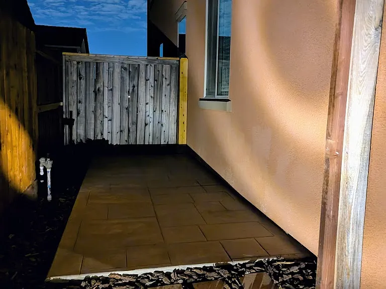 Your private side yard: a low-maintenance sanctuary designed for your busy lifestyle. Beautifully lit for evening ambiance, this tranquil space is the perfect, hassle-free urban retreat to unwind after a long day.