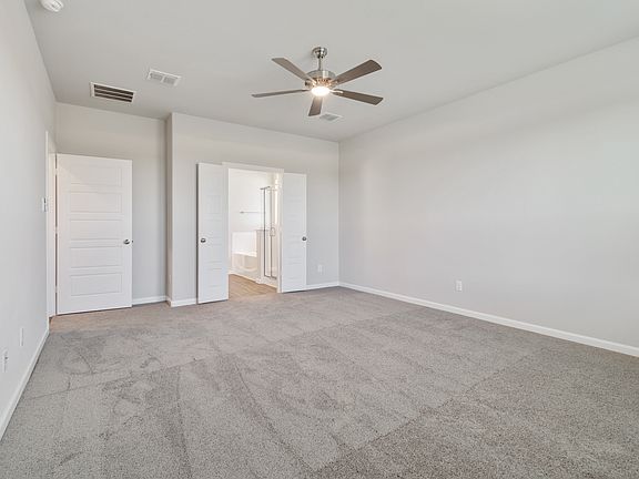 Primary bedroom in the Masters home plan by Trophy Signature Homes - REPRESENTATIVE PHOTO