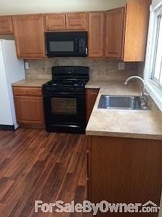 new kitchen : new appliances, floor, sink, countertops , tiled backsplash and new cabinets