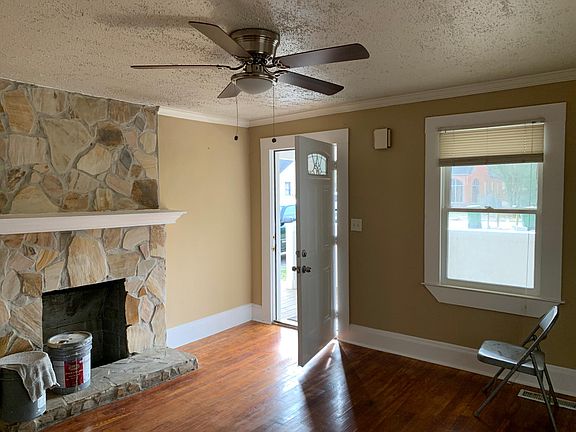 Beautiful den with sunlight, hardwood floors, ceiling fan