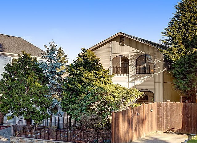 Front of Home with highly praised Hinoki Cypress trees 