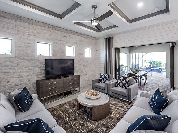 Model Representation Open gathering room with elevated ceiling and tile flooring