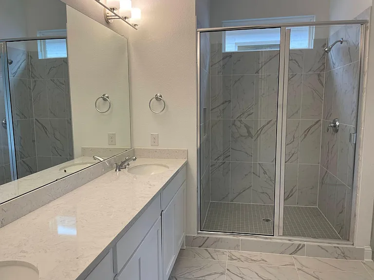 Spacious Master bath with dual sinks, Standing shower, upgraded bathroom floor tiles.