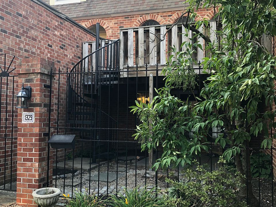 Deck over private courtyard, connected with a wrought iron spiral staircase