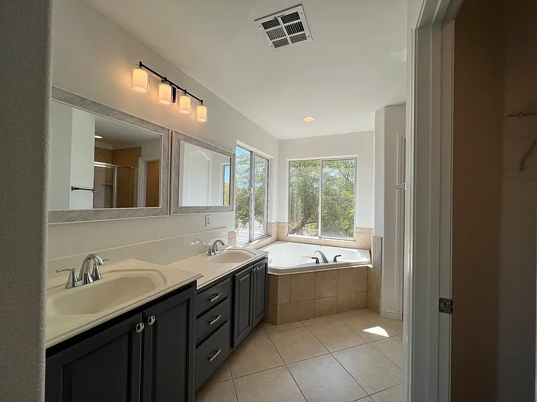 Primary bath with double sinks, and vanity space.