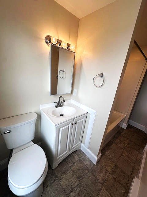 New toilet, sink, mirror, light, faucet and floor