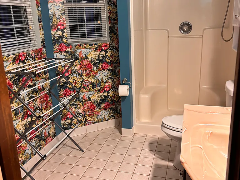 On-suite bathroom has walk-in shower and plenty of space. Drying rack pictured not included in lease, but shows bathroom's capacity.
