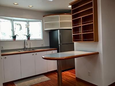 New stainless steel refrigerator and built in table with shelving.