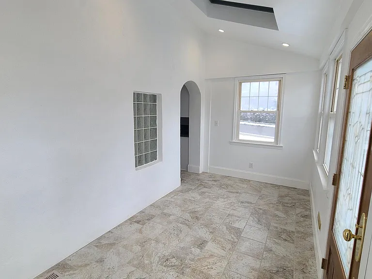 Sunroom with door from driveway and connected to the kitchen.