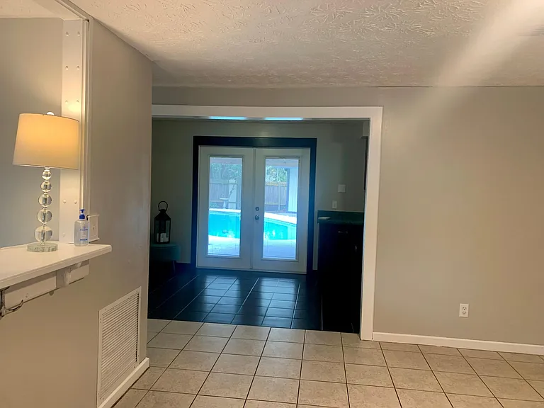 pool view through kitchen glass doors