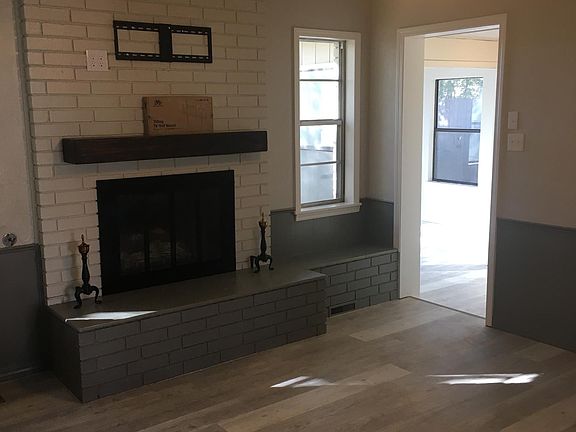 Living/TV room with fireplace. Entry to Florida Room, laundry room, and garage.