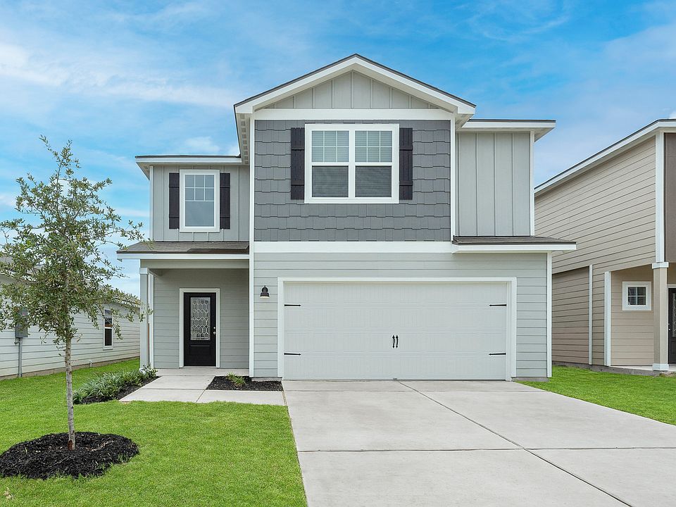 Exterior of the Torres plan with a two-car garage.