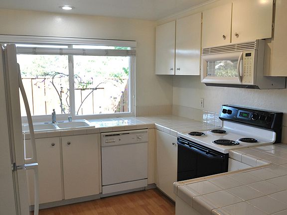 Another view of ultra-clean kitchen with lots of storage