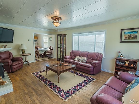 Main floor living space with NEW windows, high ceilings, & original wood floors.