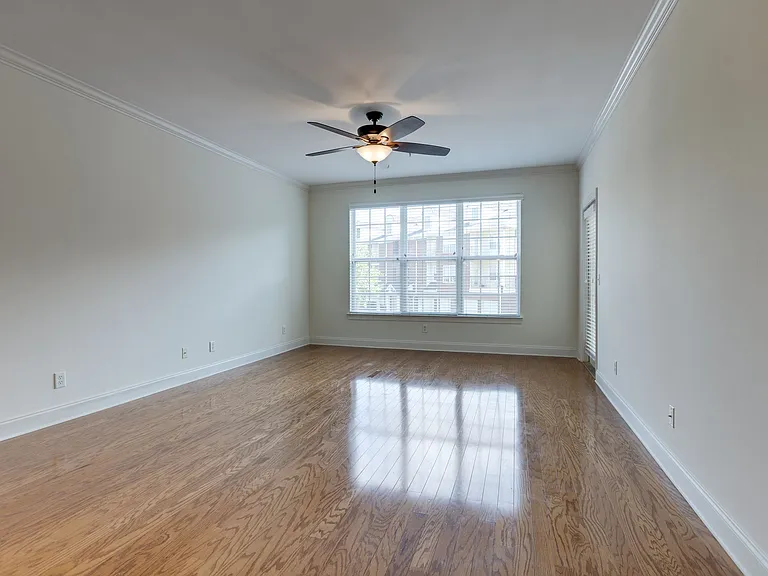 Gleaming Real Hardwood Floors make this Spacious room bright & beautiful.