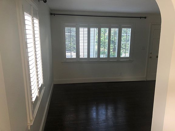 Very large living area with shiny hardwood floors!