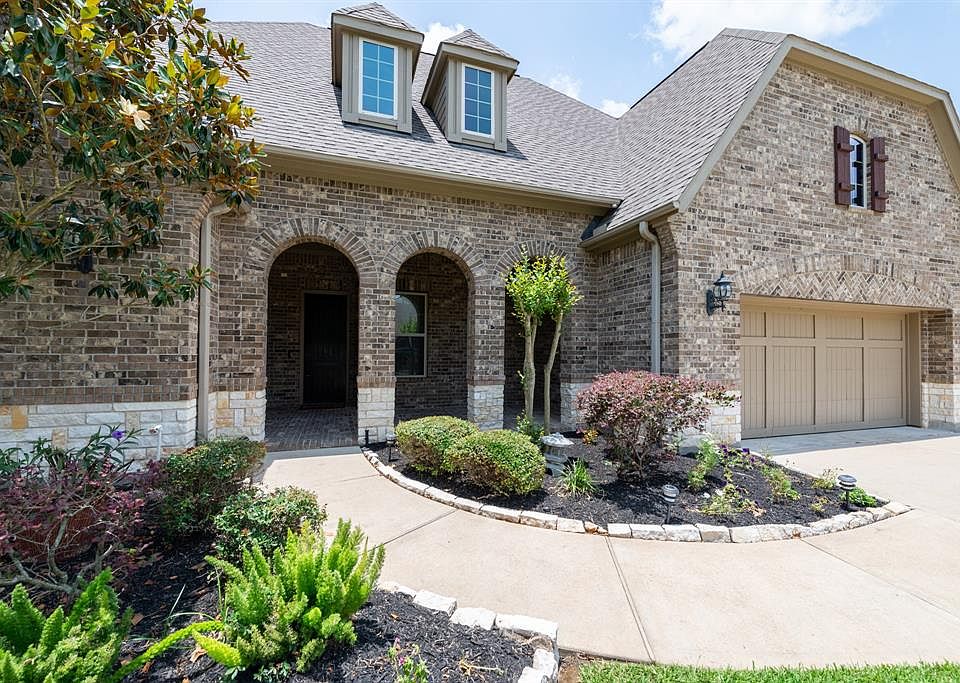 The covered front porch has great stone and brick architectural details.