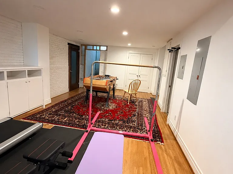 Basement gym and recreation space with hardwood floors, recessed lighting, and flexible layout.