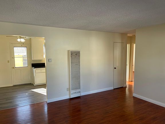 Living room as viewed from entry showing dining area and hall with closet