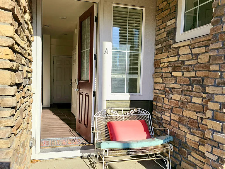 The front porch is spacious enough for a bench. Front door has keypad lock for additional security.